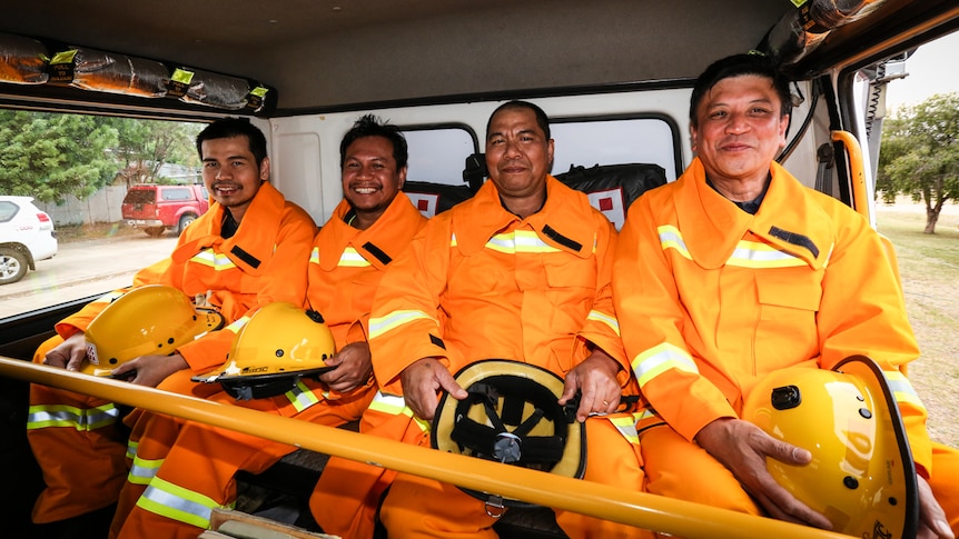 Four out of the seven new CFA recruits in Pyramid Hill sitting in the back of a fire truck.