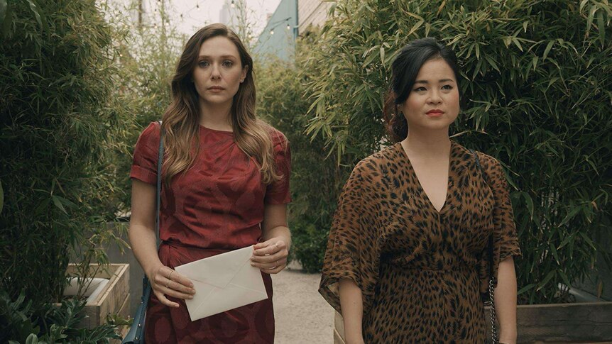 Elizabeth Olsen and Kelly Marie Tran stand next to each other in a screengrab from Sorry for Your Loss.