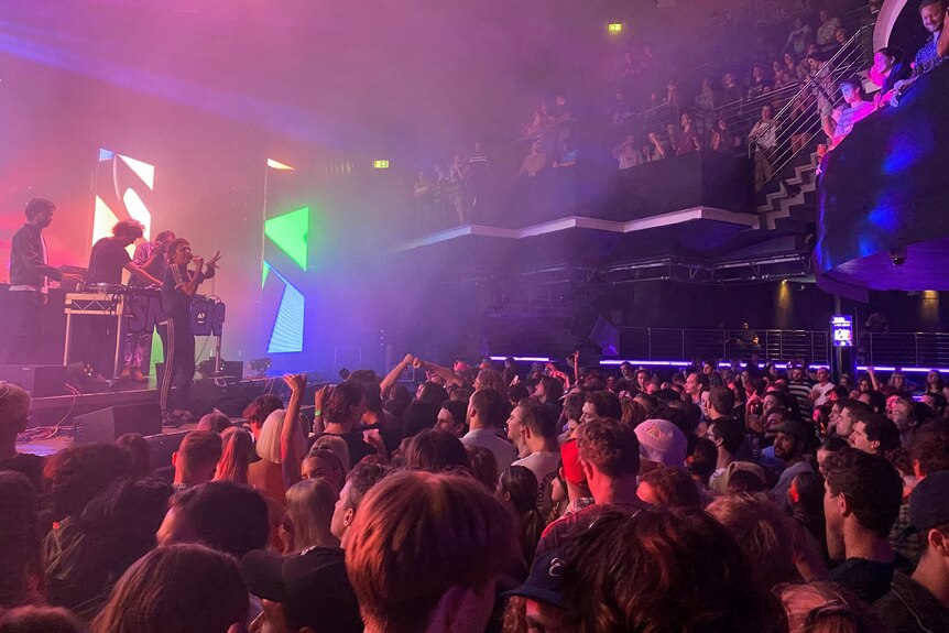 People packed inside of a nightclub watching a show