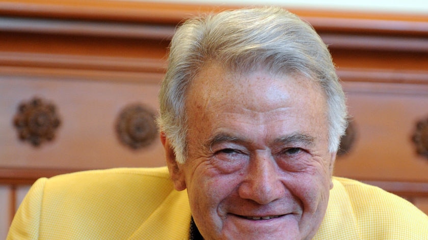 Close up of Richard Pratt wearing yellow jacket, in 2009