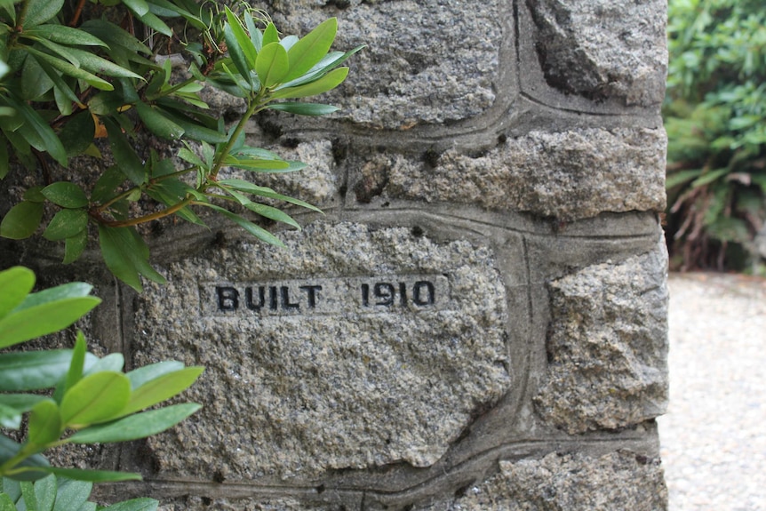 The year Mount Buffalo Chalet was built is engraved into stonework and framed by a nearby shrub