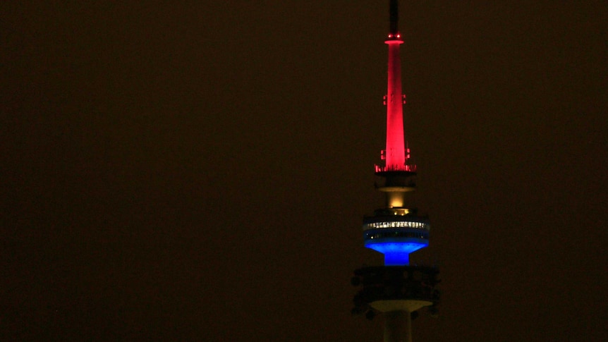 Telstra Tower on Black Mountain in Canberra lit up with blue, white and red lights following the Paris attacks.