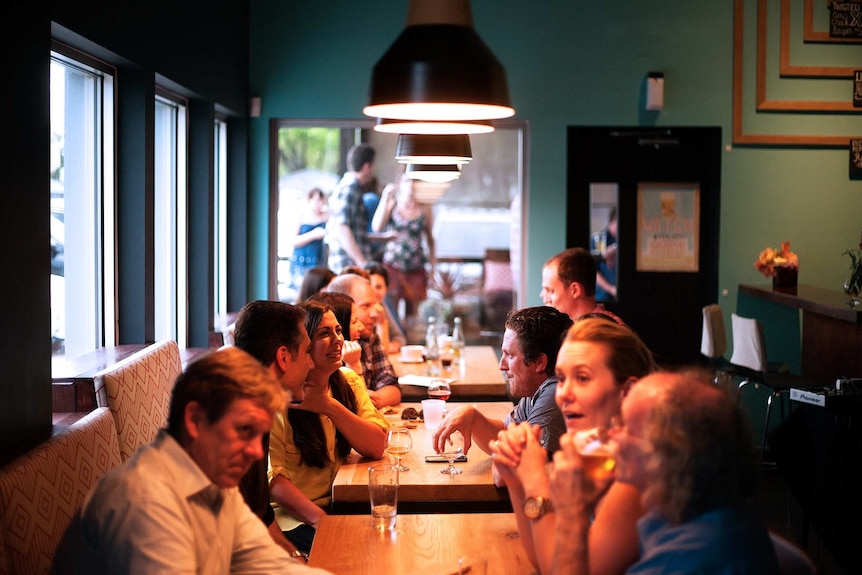 Women and women drinking at a table in a restaurant