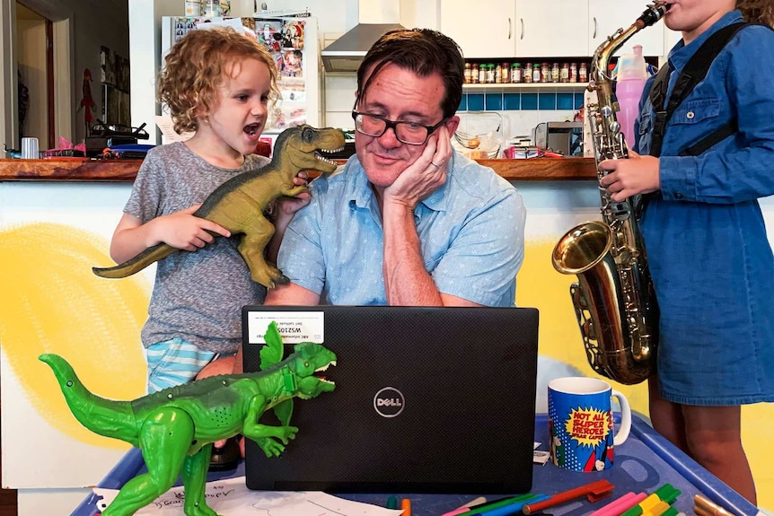 Man on computer, boy with dinosaur and girl playing saxophone in a story about tips for working from home with kids.