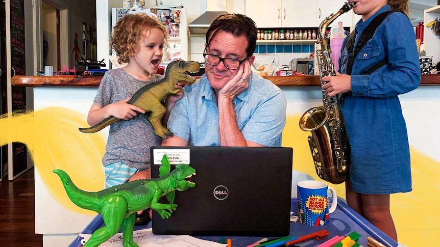 Man on computer, boy with dinosaur and girl playing saxophone in a story about tips for working from home with kids.