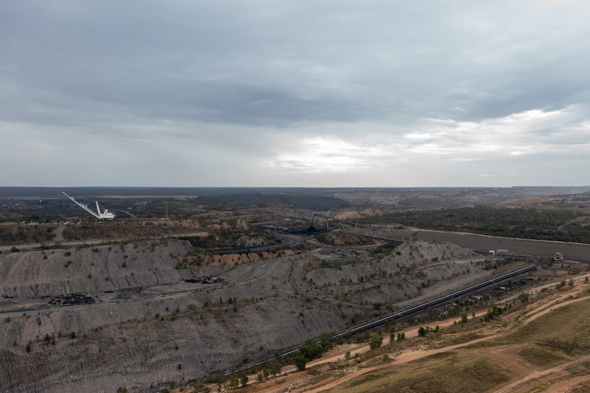 Aerial photo of coal mine with drag line excavator in the background, near Moranbah, Queensland, November 2021