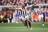 Travis Varcoe celebrates with his arms wide open after kicking the opening goal in the AFL grand final.