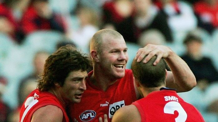 Brett Kirk, Barry Hall and Jarrad McVeigh celebrate a goal for the Sydney Swans (action pic)