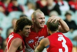 Brett Kirk, Barry Hall and Jarrad McVeigh celebrate a goal for the Sydney Swans (action pic)