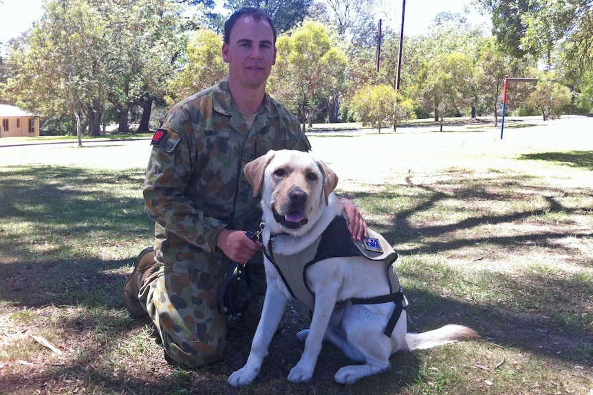 Sergeant Matthew Kelsey with newly enlisted assistance dog Gunner Murray.