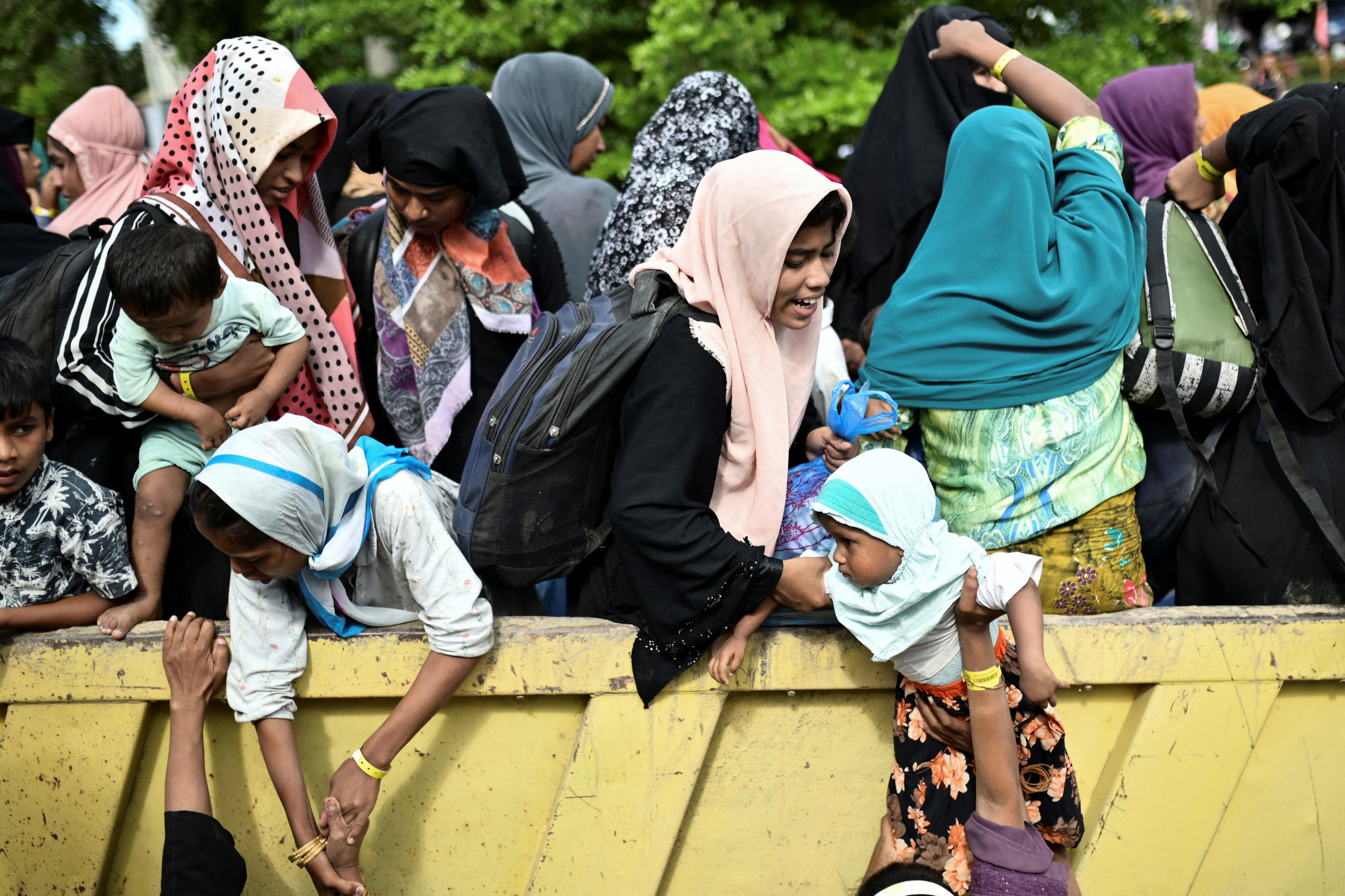 Rohingya Muslim refugees are transported as they are relocated from their temporary shelter 