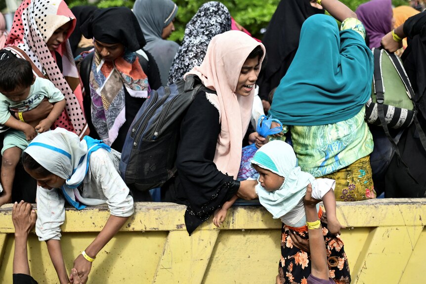 Rohingya Muslim refugees are transported as they are relocated from their temporary shelter 