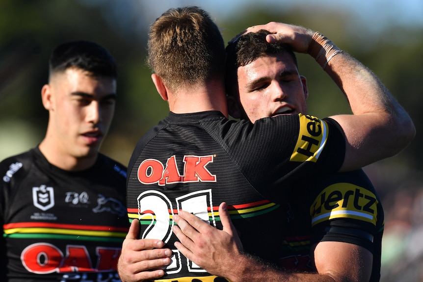 Two Penrith Panthers NRL players embrace after a try was scored against South Sydney.