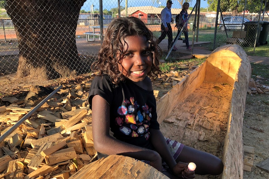 Girl sitting in dugout canoe