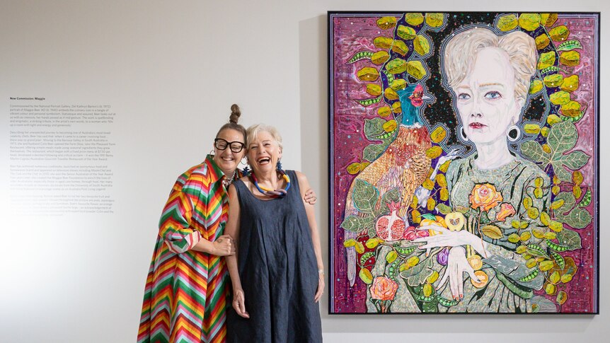 Maggie Beer and Del Kathryn Barton stand in front of a portrait of Maggie Beer.