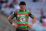 Rugby League player looks down in anguish with his hands on his hips.