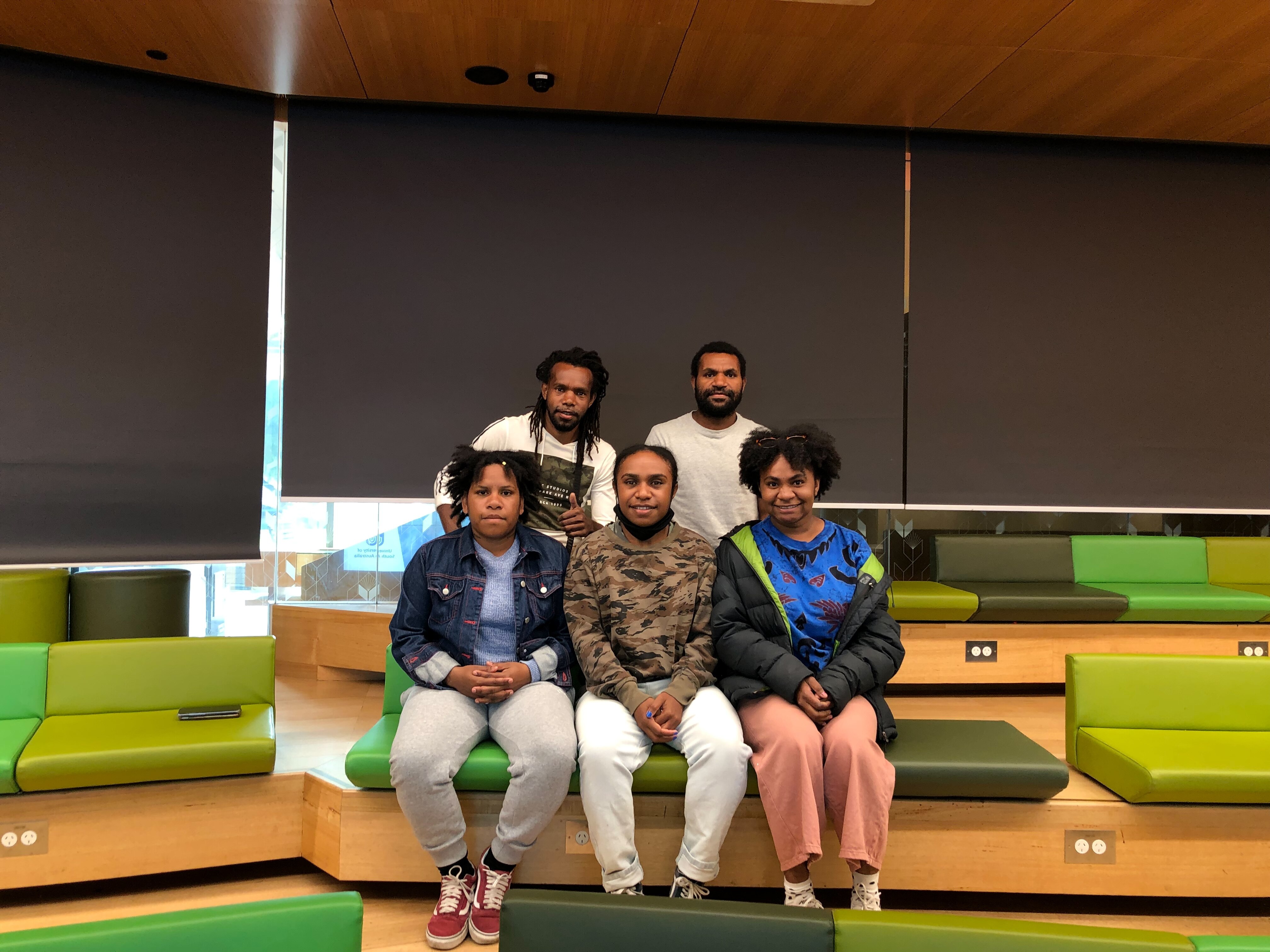 Five West Papuan students pose in a classroom for a photo.
