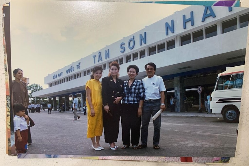 Old photograph of Peter Nguyen's family in outside building in Vietnam.