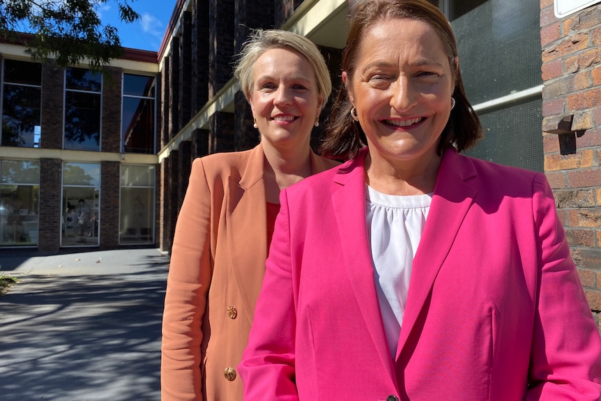 Two women in front of a building