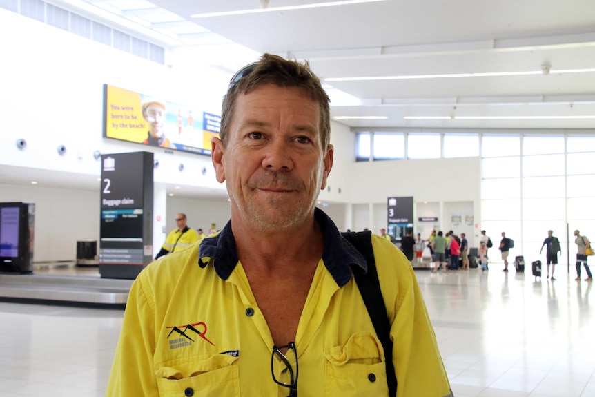 Lithium project worker Ty standing at Perth Airport.