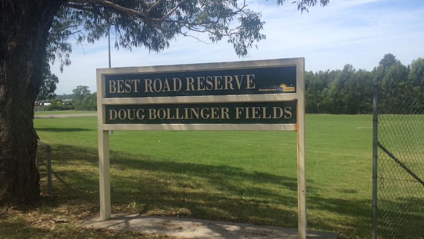 A sign in front of a park that reads Best Road Reserve, Doug Bollinger Fields.