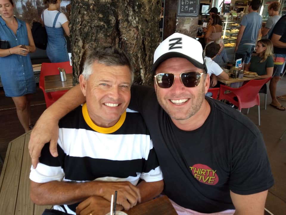 Two men smiling at the camera