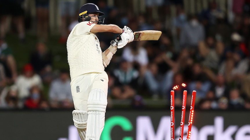 England batter Mark Wood completes his strokes as a cricket ball hits his stumps.