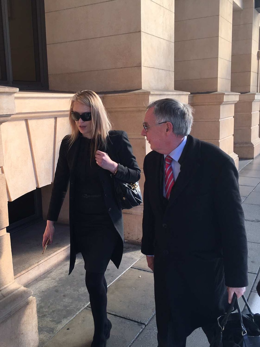 Alana Bartels (left) walks with lawyer Stephen Ey.
