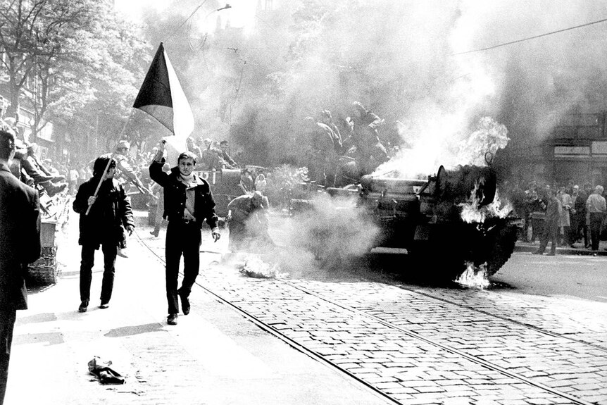 A Soviet tank burns in Prague following the 1968 invasion.