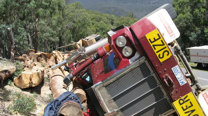 A log truck lies on its side on Poatina Road, near Poatina in Tasmania's central highlands.