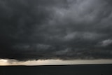 dark clouds over an ocean