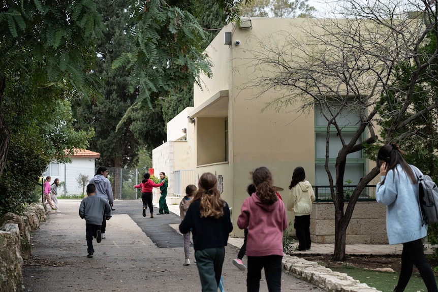Children run back to class at the Oasis of Peace school after the lunch time bell rings.