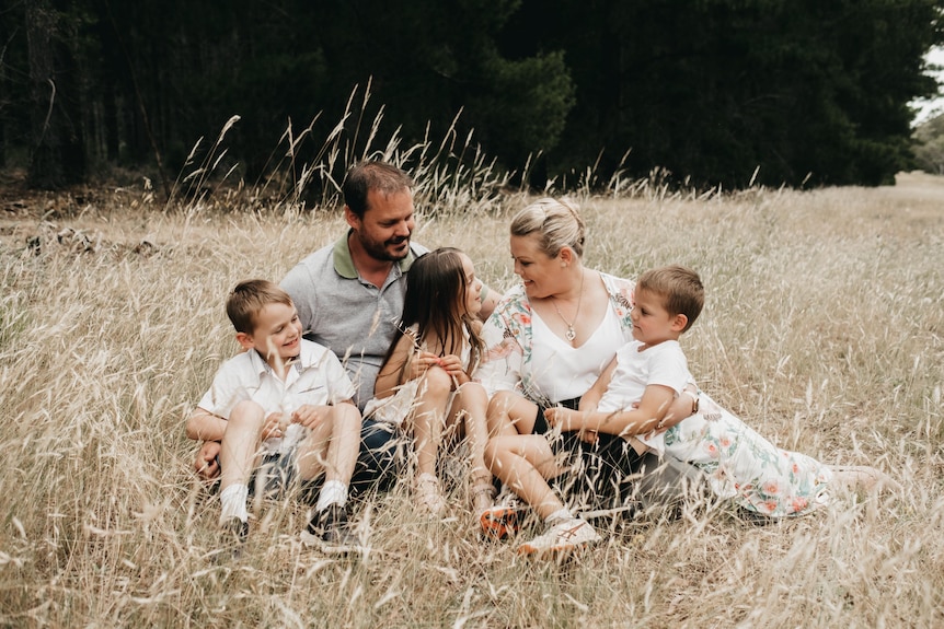 Two parents and three children in a photo shoot