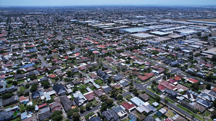 An aerial view of streets in suburban Melbourne, on a sunny day.