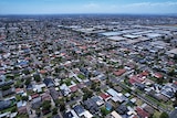 An aerial view of streets in suburban Melbourne, on a sunny day.