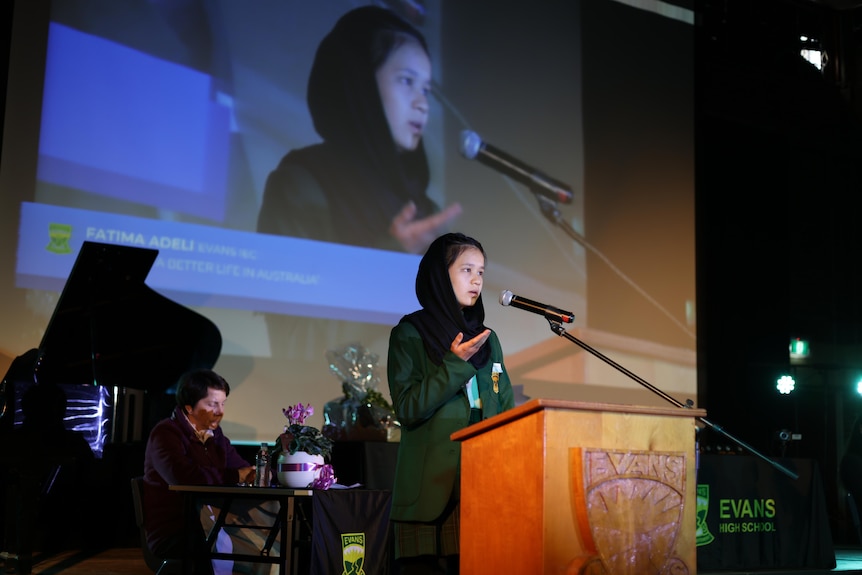 A girl speaks on stage