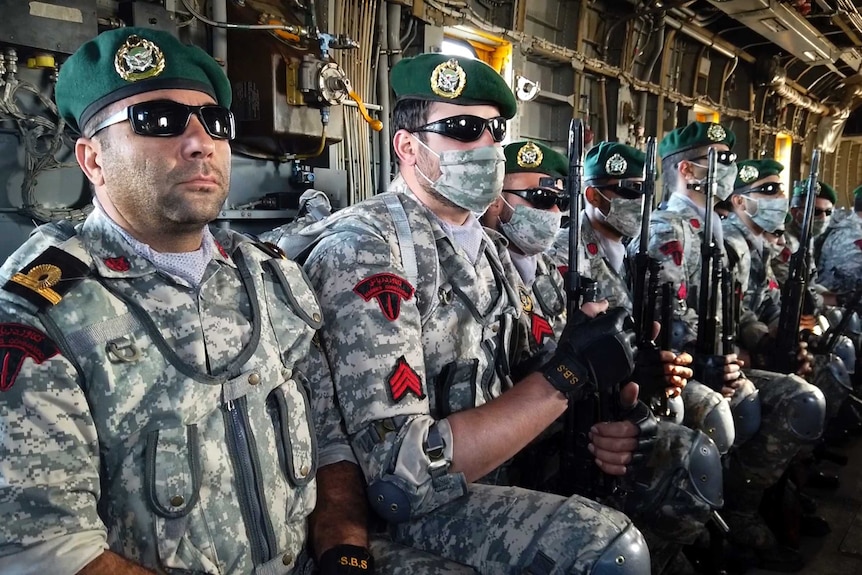 Iranian troops sitting in a helicopter during a navy drill