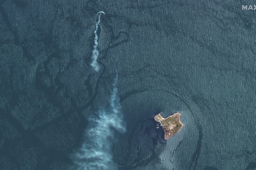 Satellite image shows a trail of smoke nearby a moving ship.