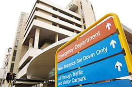 Upshot of Sir Charles Gairdner Hospital in Perth with emergency department sign in foreground.