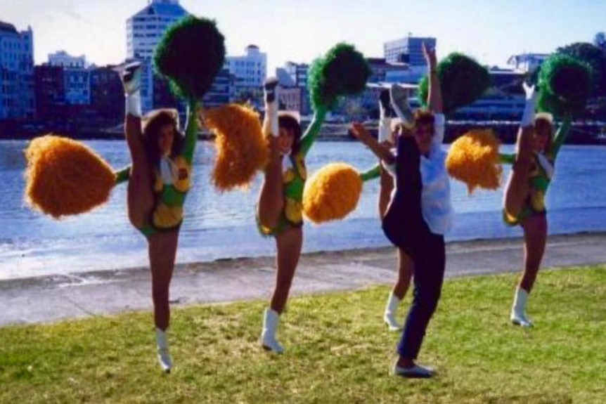 Cheerleaders perform a high kick