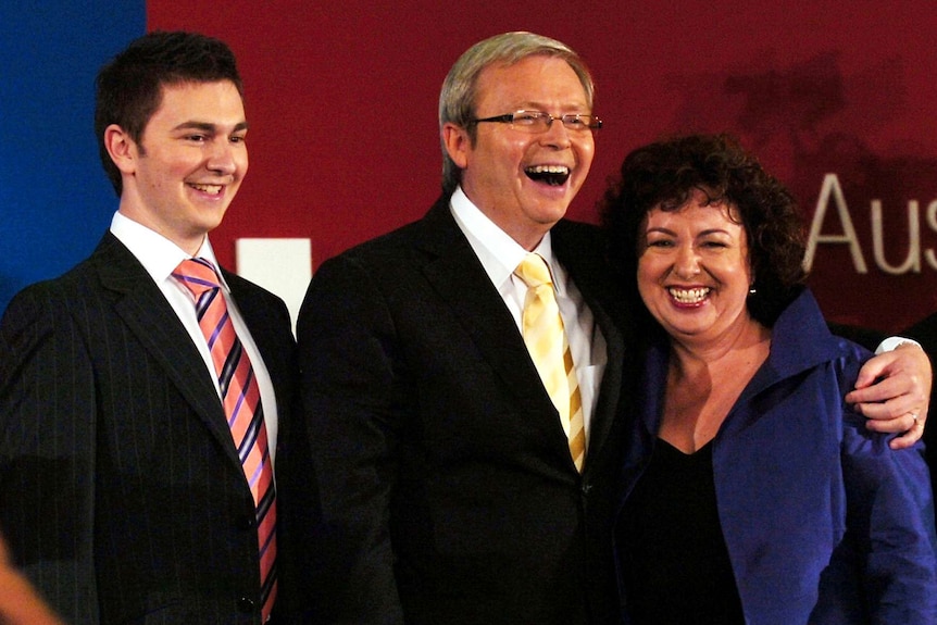 Rudd hugs his wife and son while claiming the prime ministership
