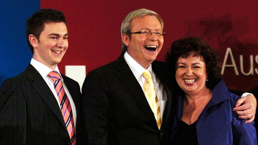 Rudd hugs his wife and son while claiming the prime ministership