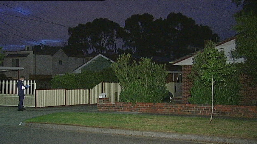 Police officer outside house in Noble Park where woman was stabbed