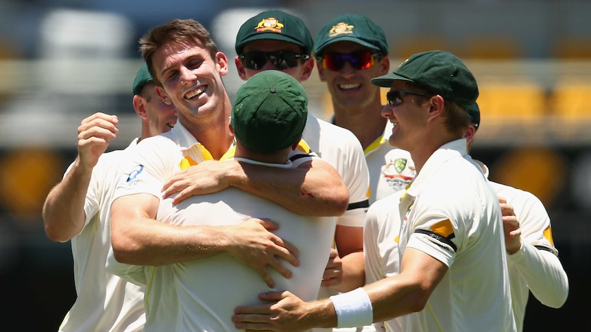 Australia's Mitchell Marsh celebrates the wicket of India's Shikhar Dhawan on day one at the Gabba.