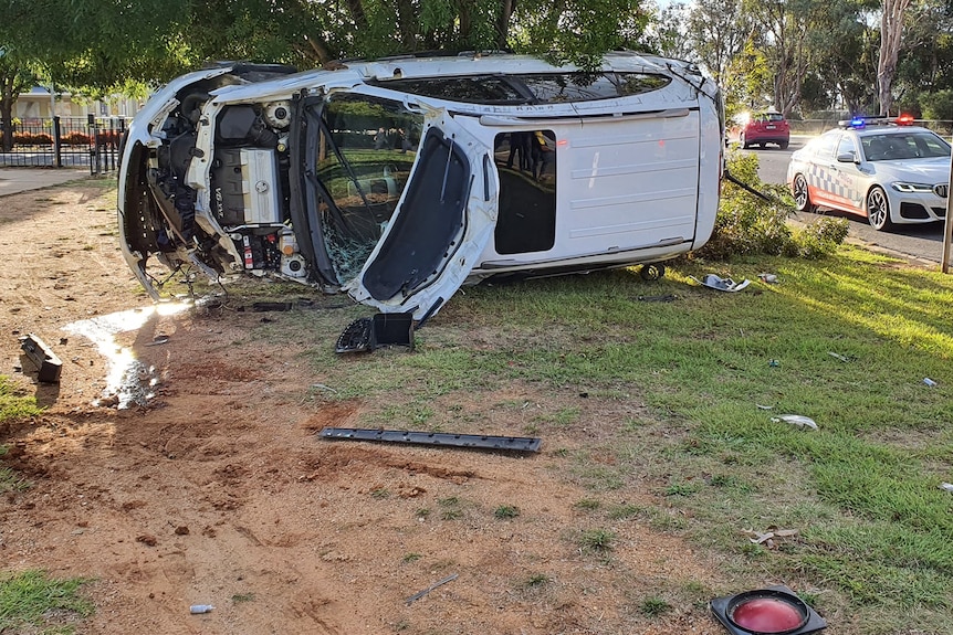 Image of white car on its side 