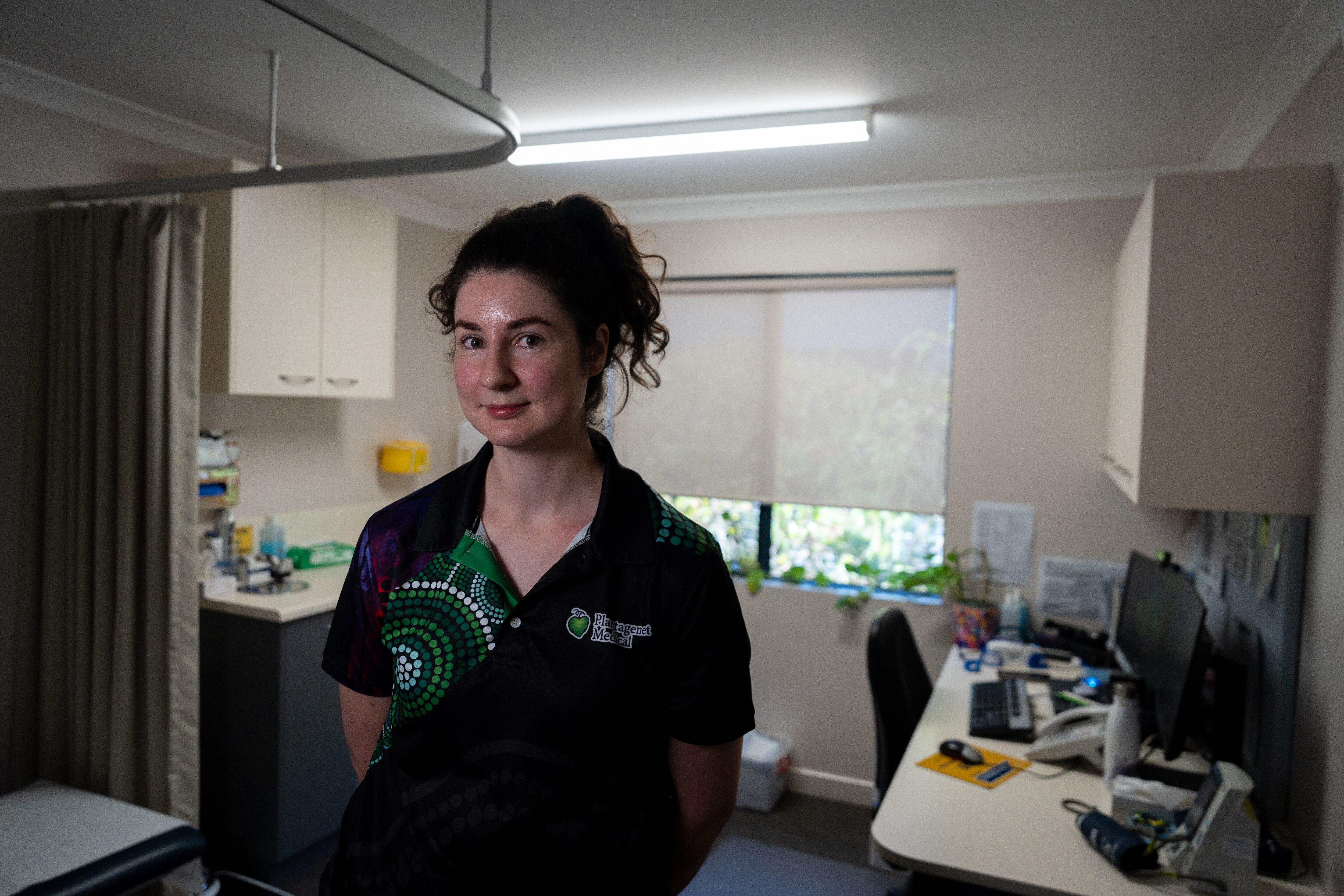 Alice standing in her general practitioner office.