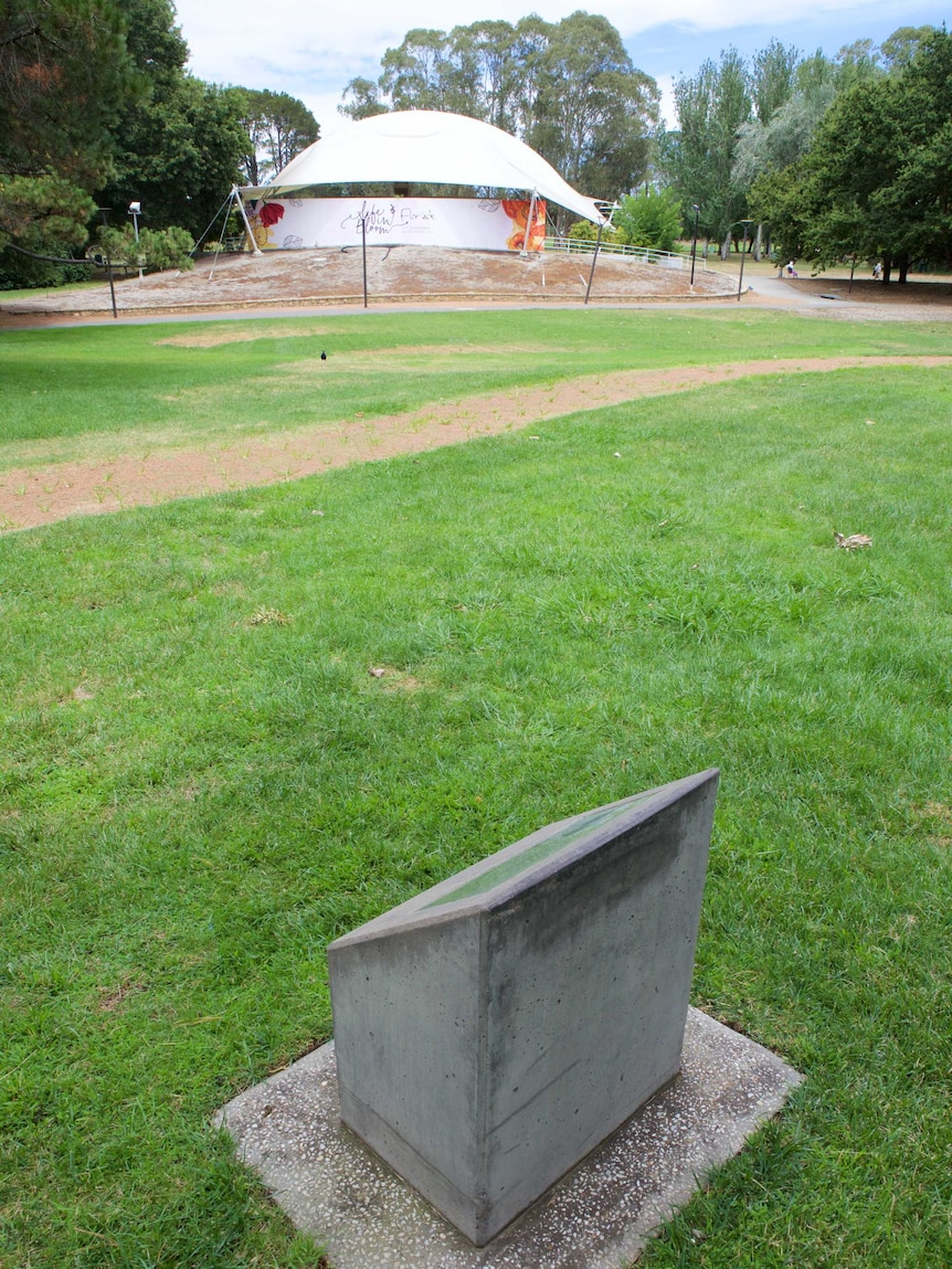 A concrete plaque behind Stage 88 denotes the rough location of the buried artwork.