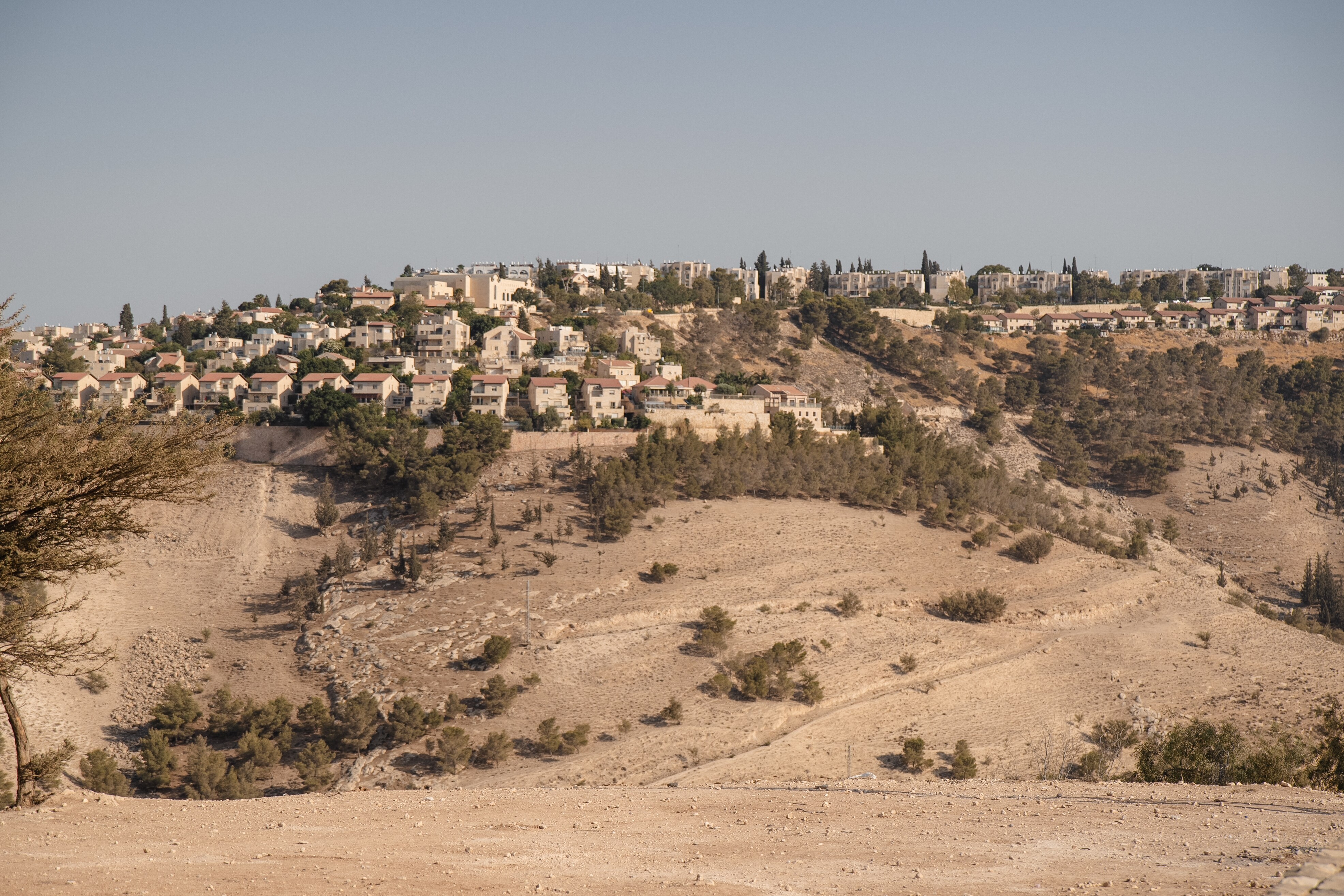 An Israeli settlement built on a dusty hill.