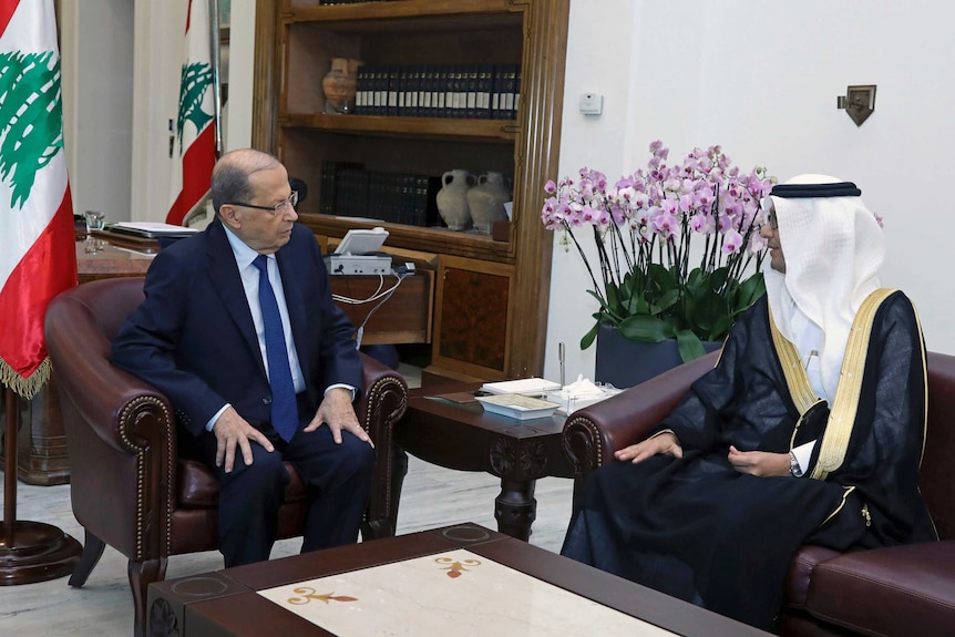 Lebanese President Michel Aoun talks to Walid al-Bukha, the Saudi charge d'affaires in Lebanon, in an office.