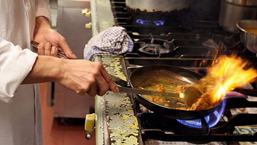 A chef cooks in a restaurant.